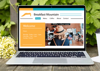 Layout image of the Breakfast Mountain website on a laptop