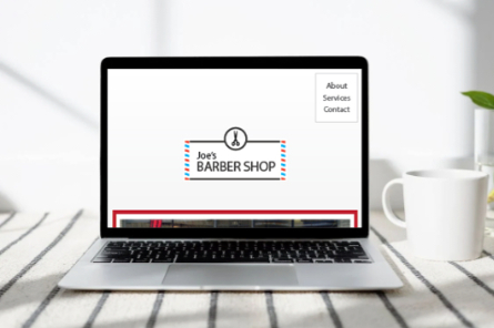 Layout image of Joe's Barbershop website on a laptop